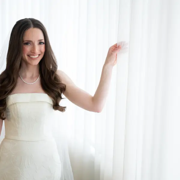 Bride styled with fine jewelry complementing her wedding dress neckline