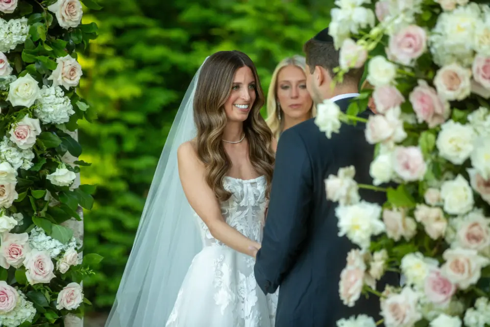 Bride wearing diamond jewelry styled to her wedding dress neckline