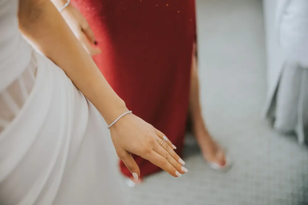 Bride showcasing fine diamond jewelry pieces for her wedding